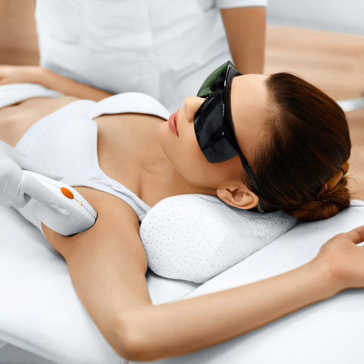 Body Care. Underarm Laser Hair Removal. Beautician Removing Hair Of Young Woman's Armpit. Laser Epilation Treatment In Cosmetic Beauty Clinic. Hairless Smooth And Soft Skin. Health And Beauty Concept.