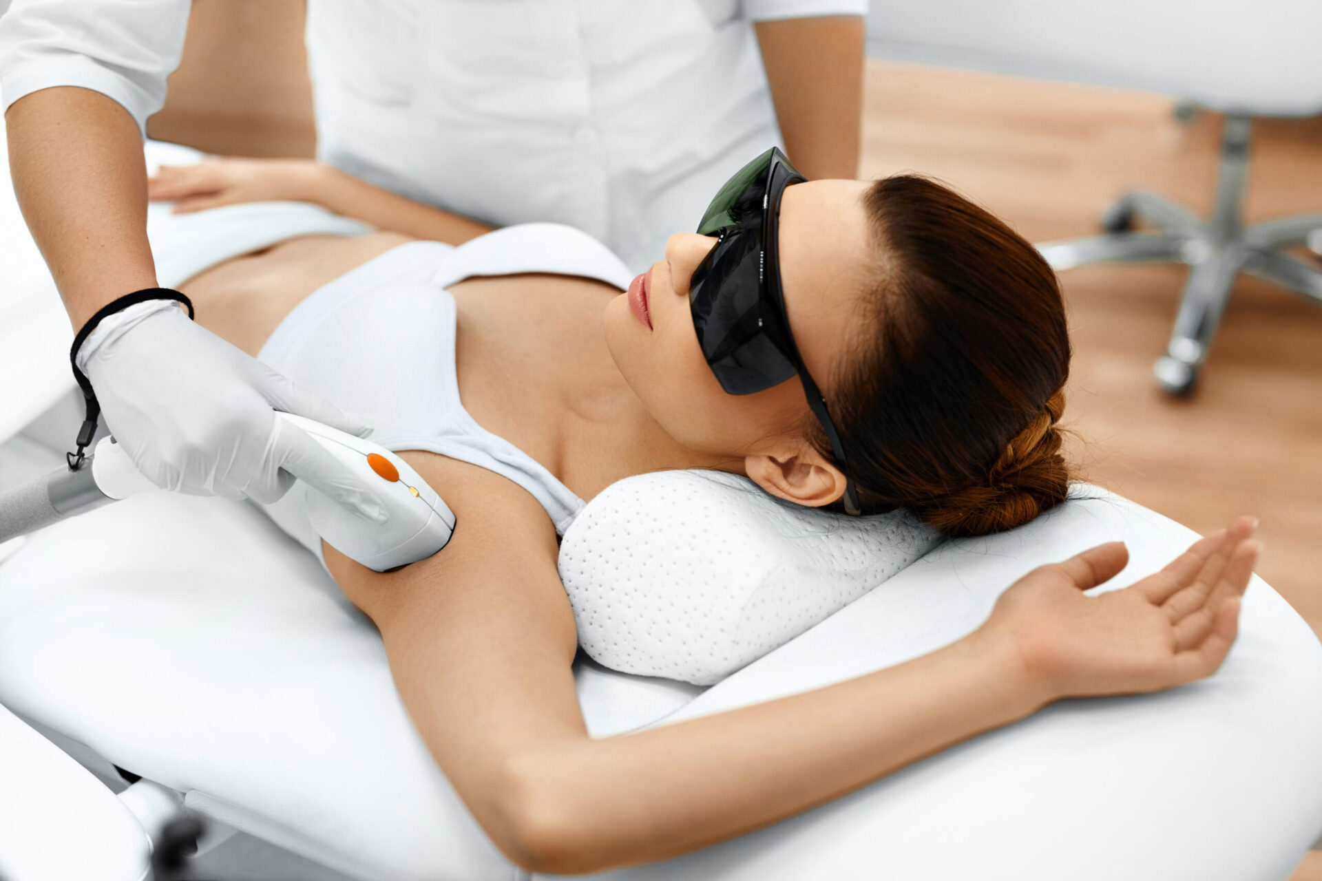 Body Care. Underarm Laser Hair Removal. Beautician Removing Hair Of Young Woman's Armpit. Laser Epilation Treatment In Cosmetic Beauty Clinic. Hairless Smooth And Soft Skin. Health And Beauty Concept.